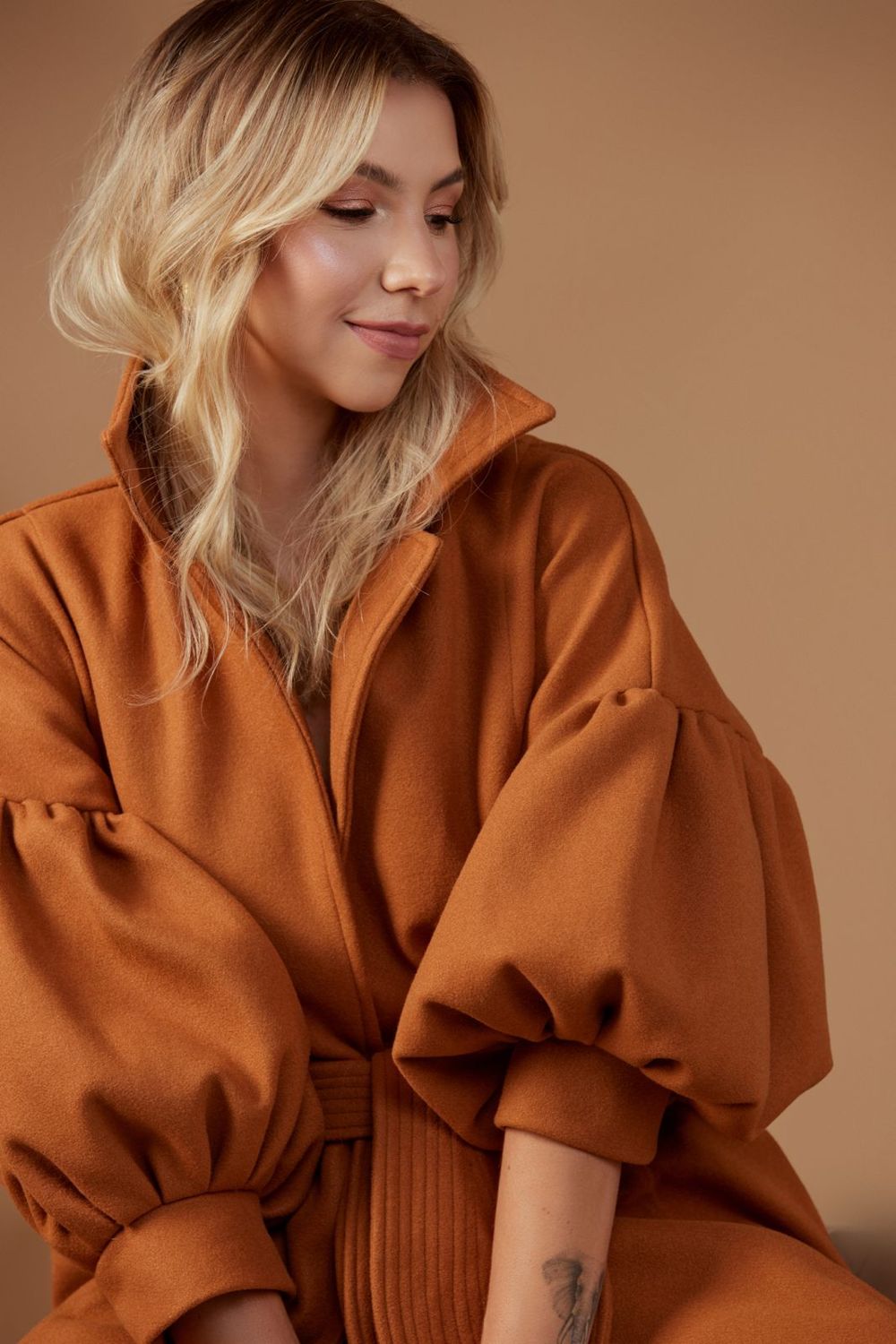 Daniella Moscarella in a rust coat