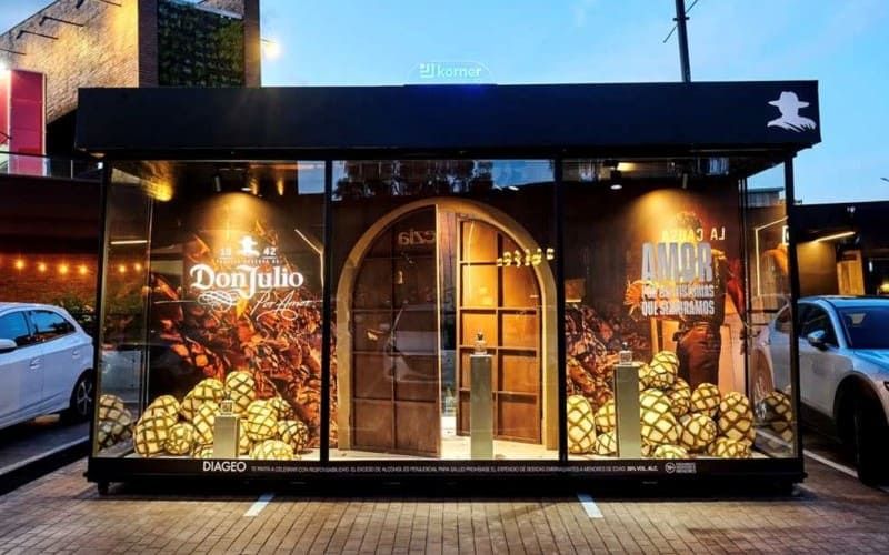 A Don Julio pop up kiosk at dusk