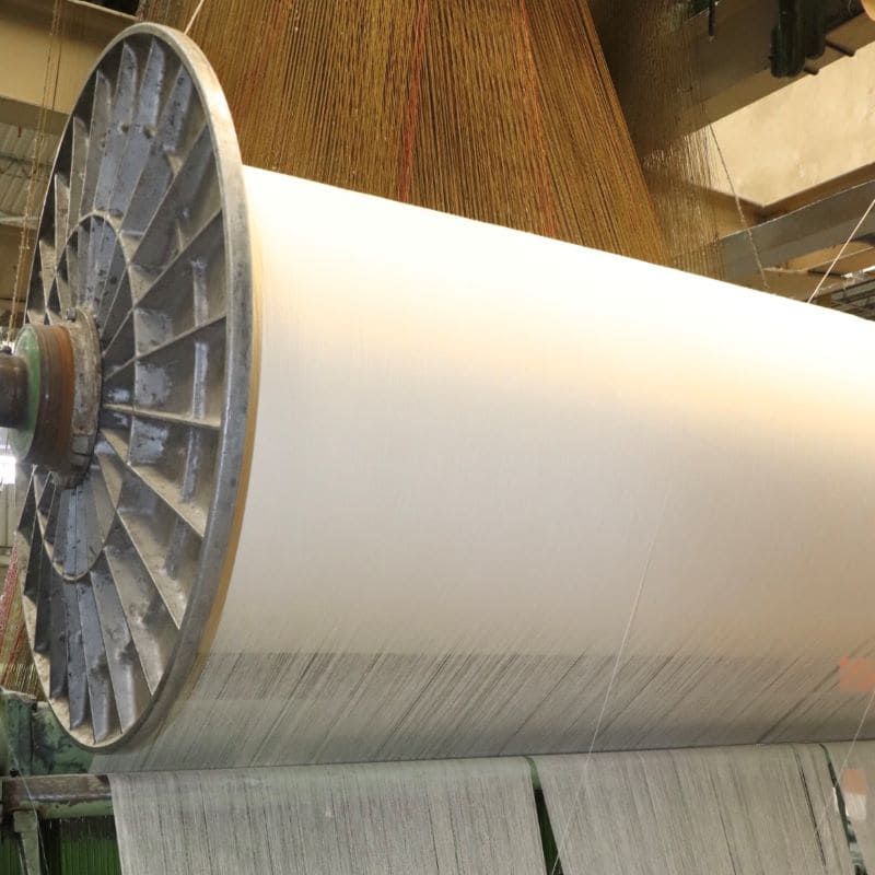 A roll of white Peruvian cotton fabric