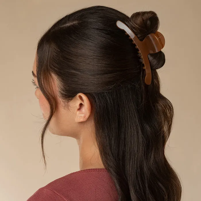 Mocha arched claw clip holding a half-up style