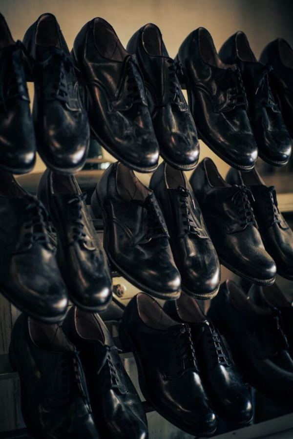 Rows of black Alden shoes on a shelf