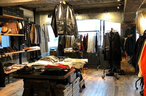 Inside ARCH TOKYO: wooden floor, jackets and knitwear on the rails