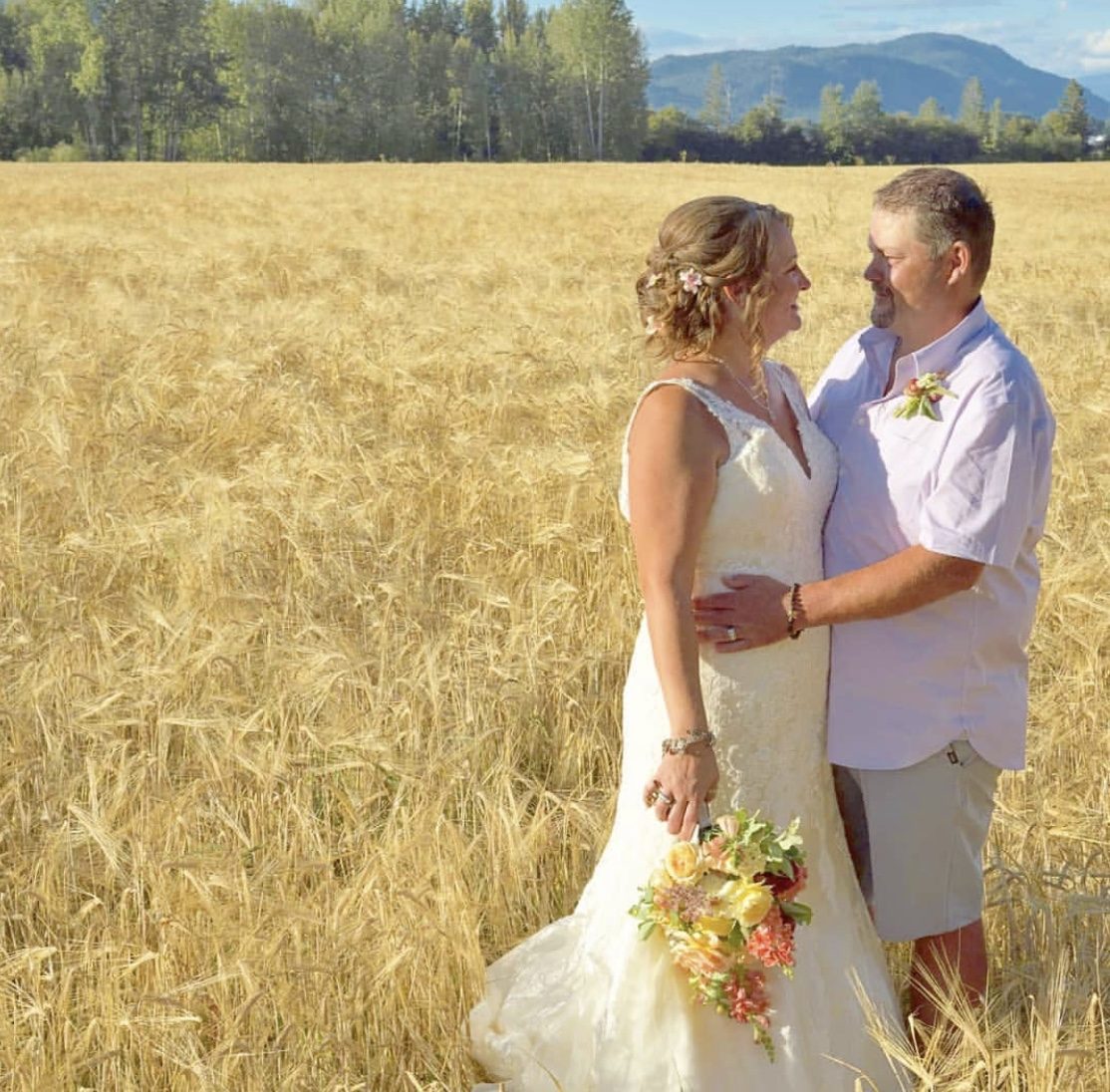 Couple embracing in a golden wheat field