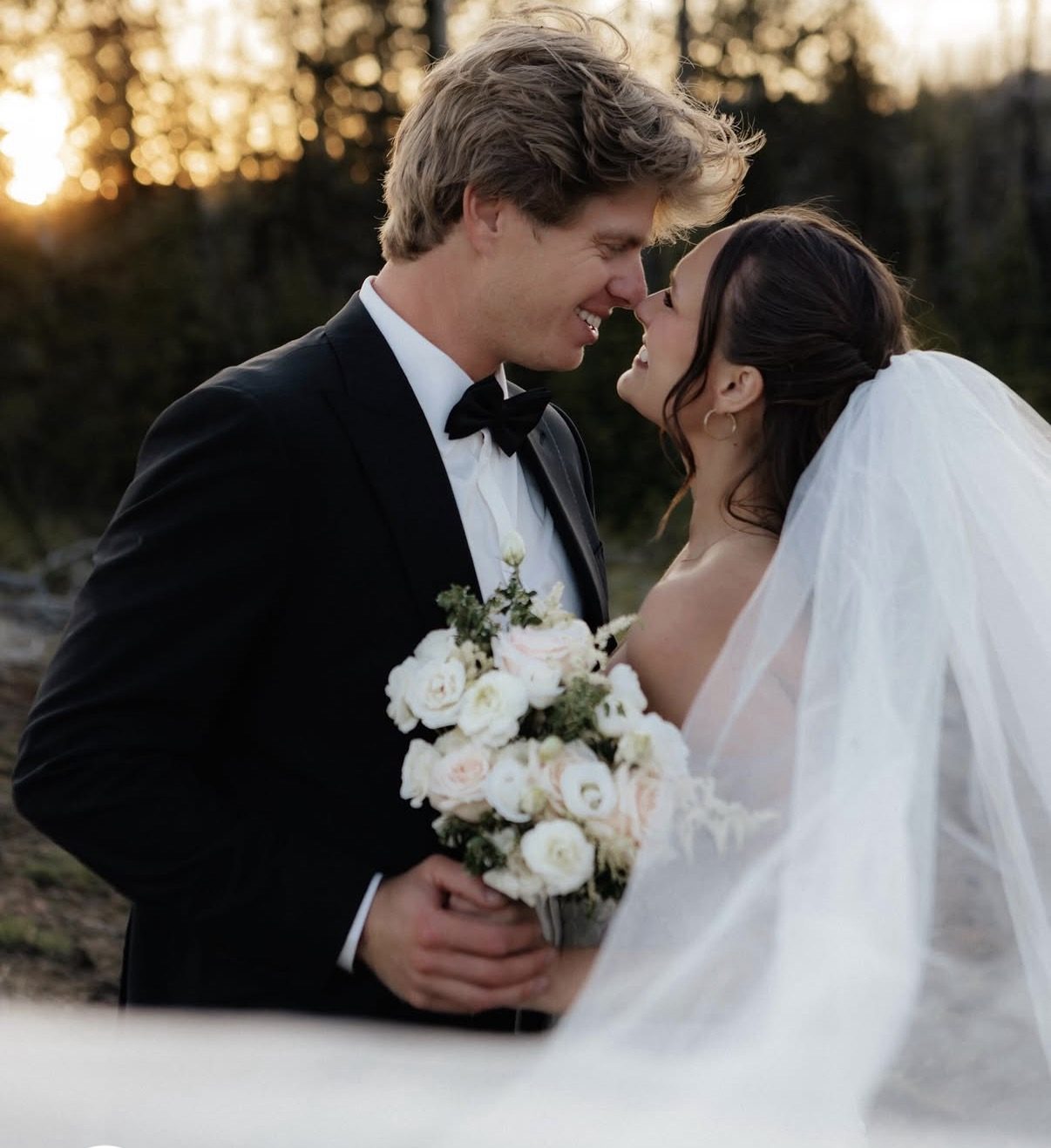 Bride and groom sharing a kiss at golden hour