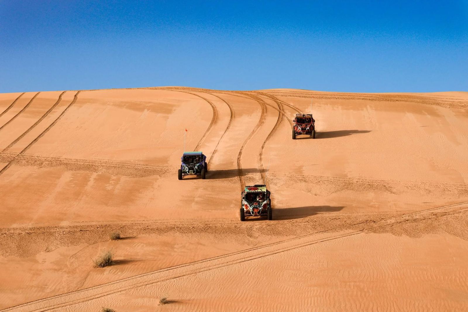 Buggies crossing the dunes in Liwa