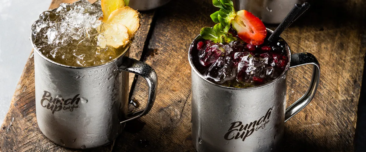 Two Punch Cup cocktails in copper mugs